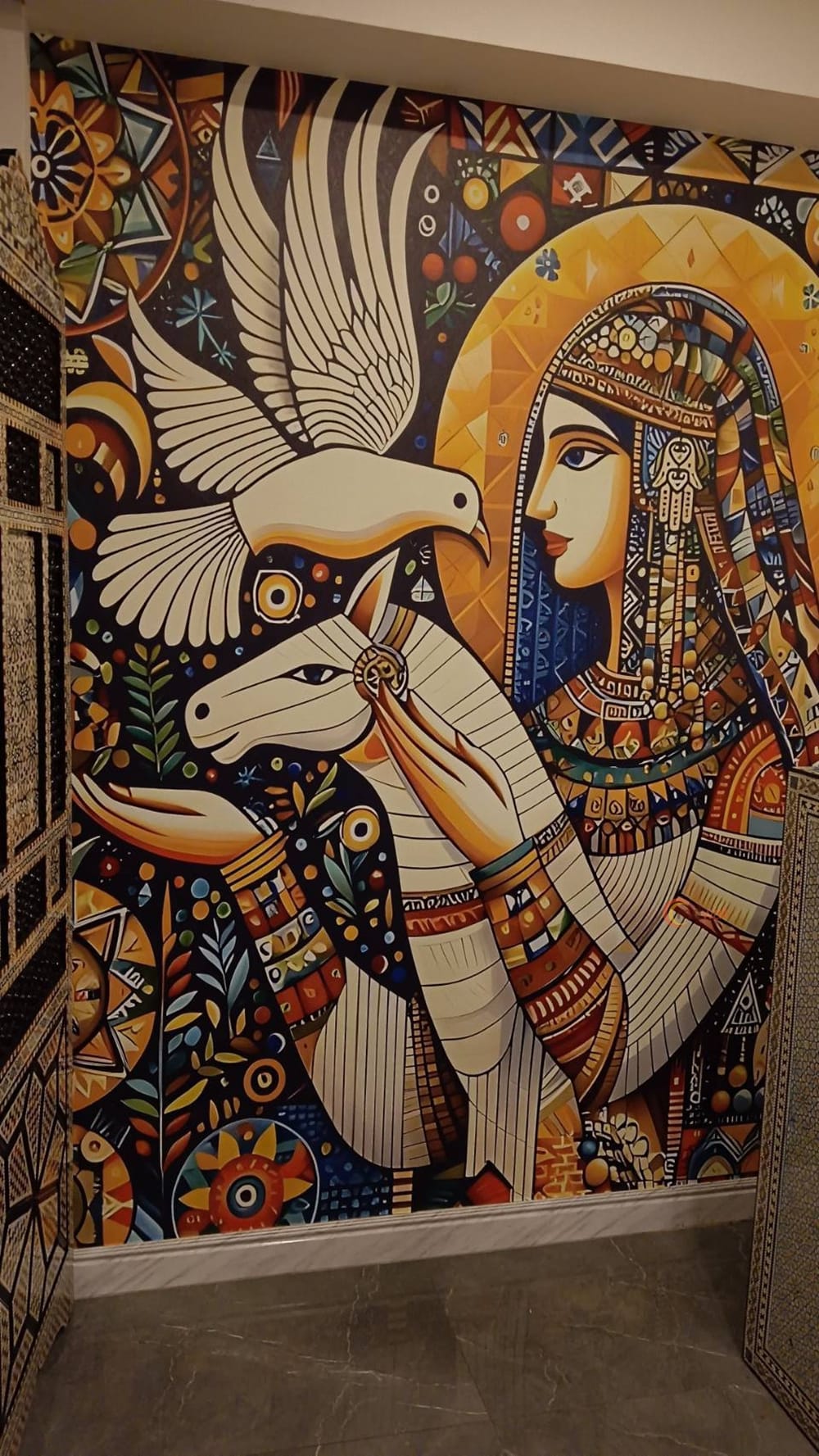 Egyptian-inspired mural covering a restaurant wall from floor to ceiling