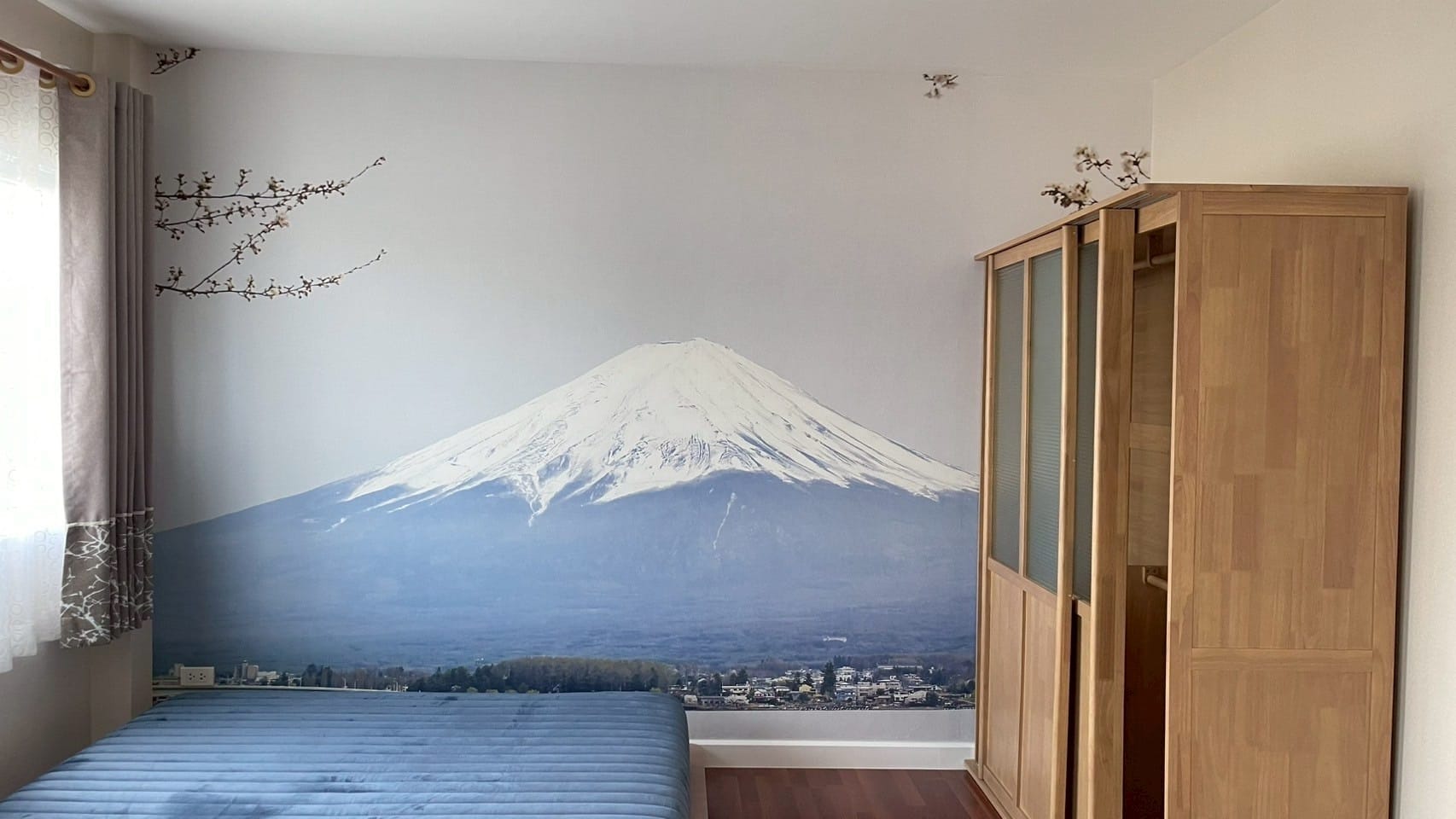 Soft-toned Mount Fuji mural wrapping a bedroom corner