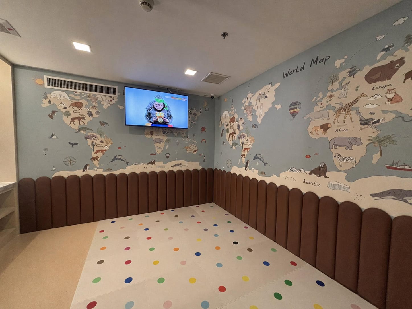 Illustrated world map mural in a children's play room