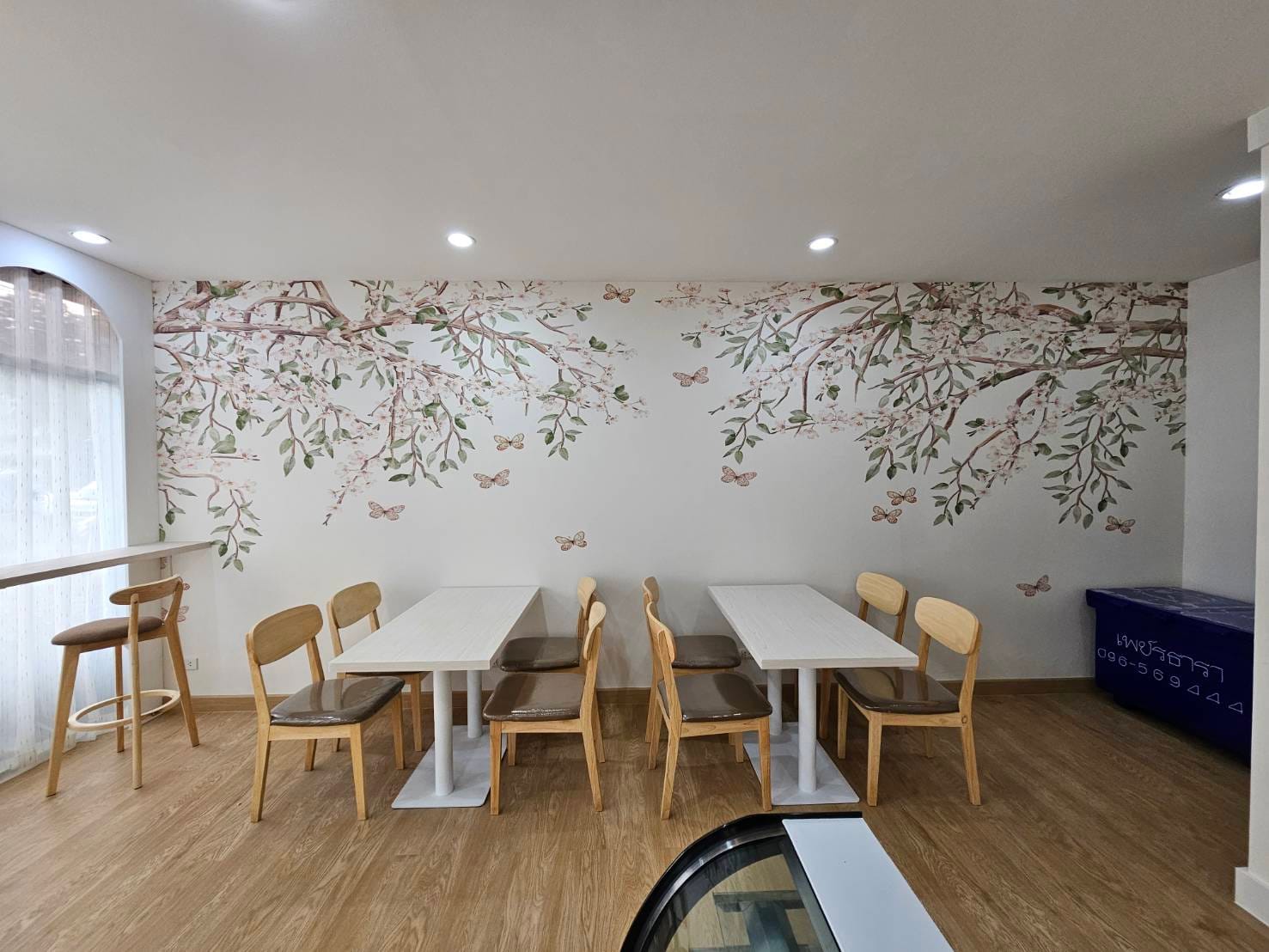 Blooming Blossom cherry blossom mural across a cafe seating wall