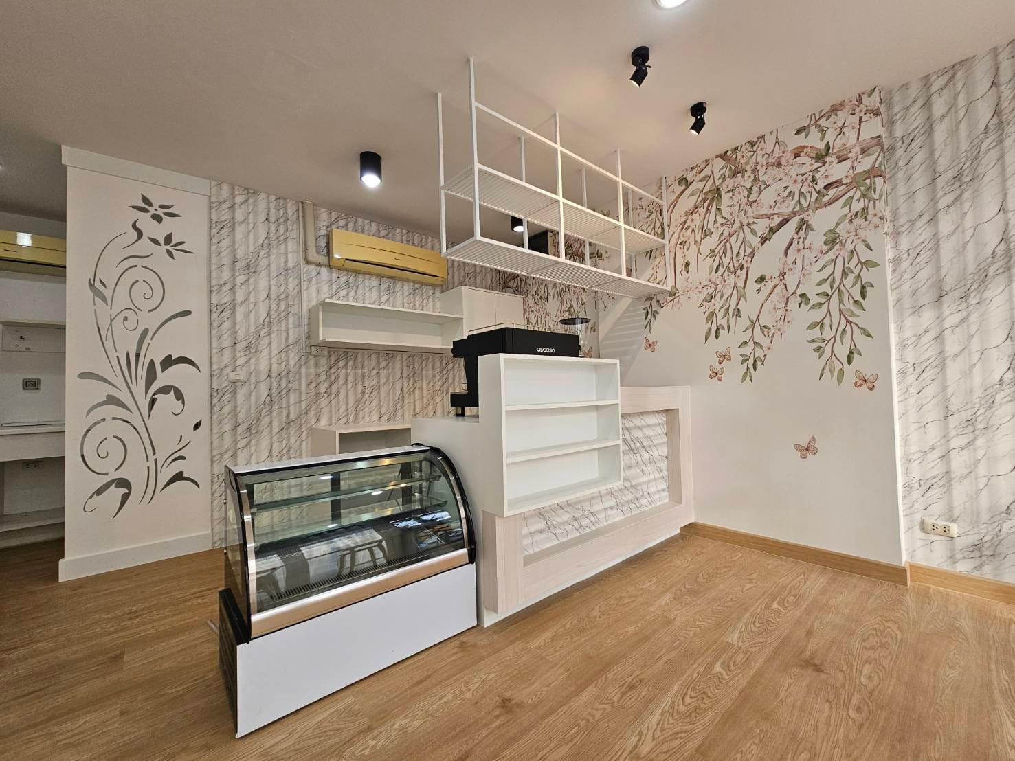 Blooming Blossom mural above the counter of a small bakery cafe